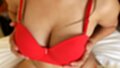 Cupping her big tits wearing red bra