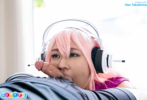 Nao Takashima wearing headset on her knees sucking cock
