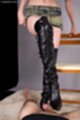 Standing beside chair wearing thigh high boots teasing cock