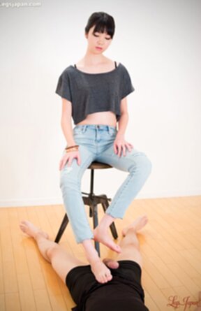Matsuda Anna sitting on stool wearing jeans giving footjob with bare feet