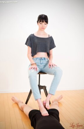 Matsuda Anna sitting on stool wearing jeans giving footjob with bare feet