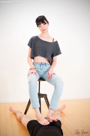 Matsuda Anna sitting on stool wearing jeans giving footjob with bare feet