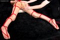 Lying on her front naked legs spread bound with rope