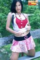 Long hair over her shoulder pulling top up wearing skirt